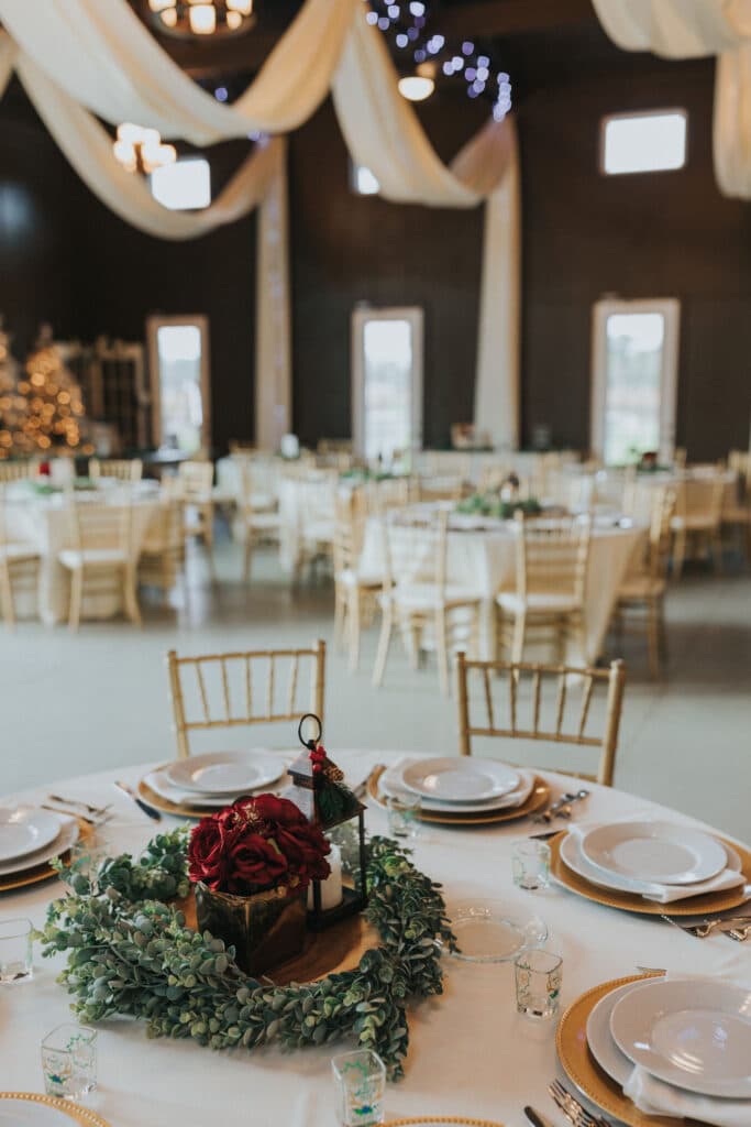 wedding reception with gold chairs and beautiful centerpieces