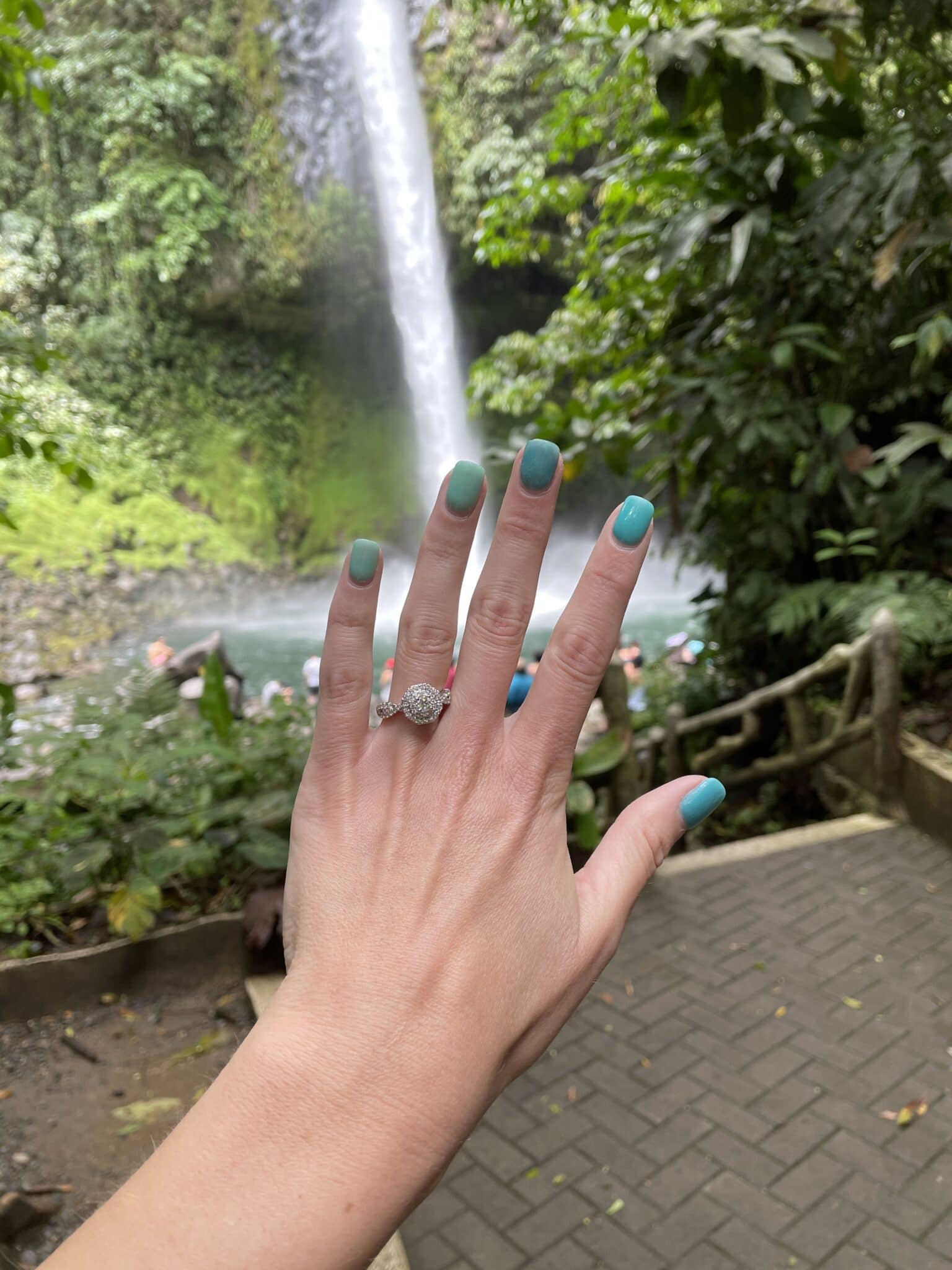 bride's left hand with her new engagement ring on her ring finger after the costa rica waterfall marriage proposal.
