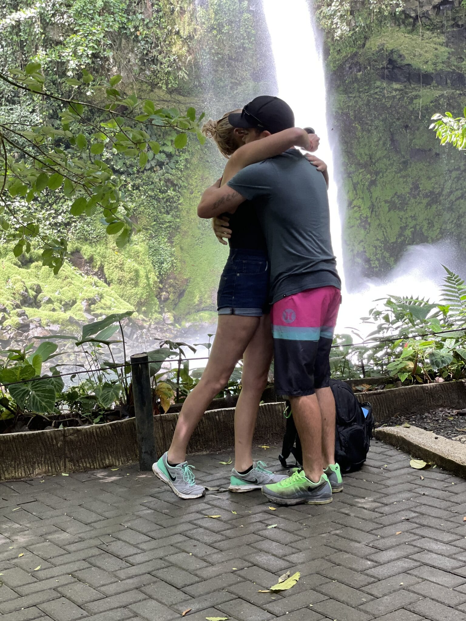couple hugging after their costa rica waterfall marriage proposal.