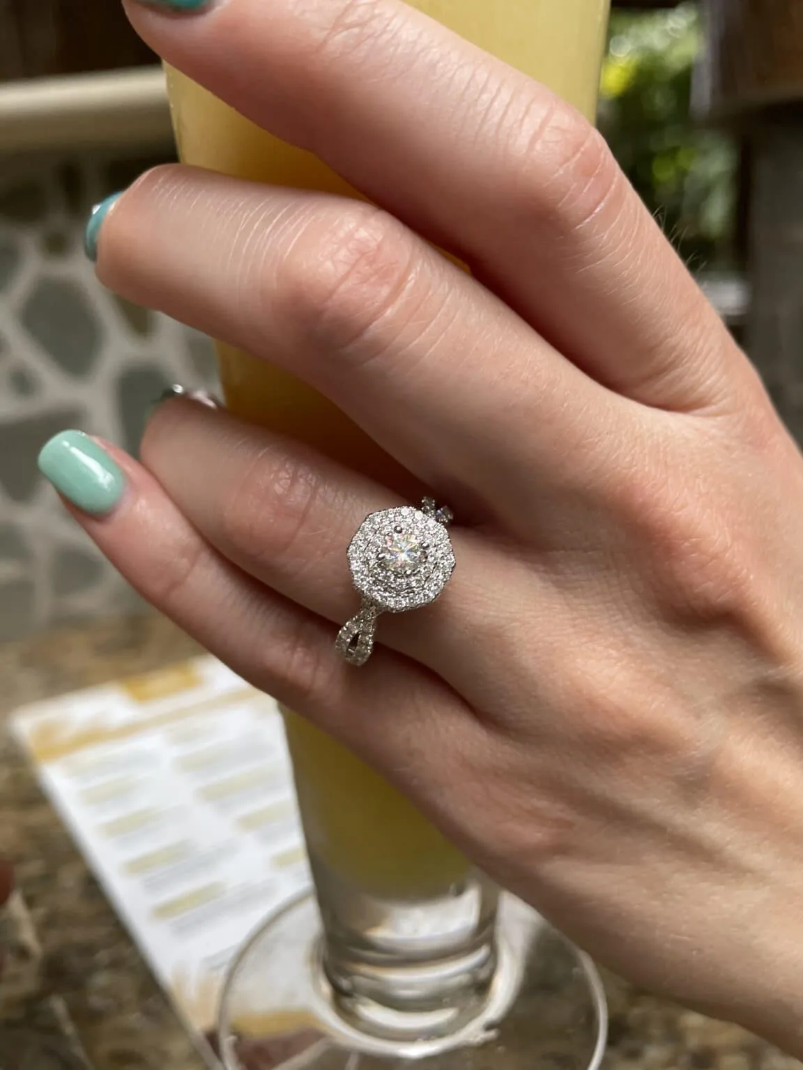 bride's left hand with her new engagement ring after the costa rica waterfall marriage proposal.
