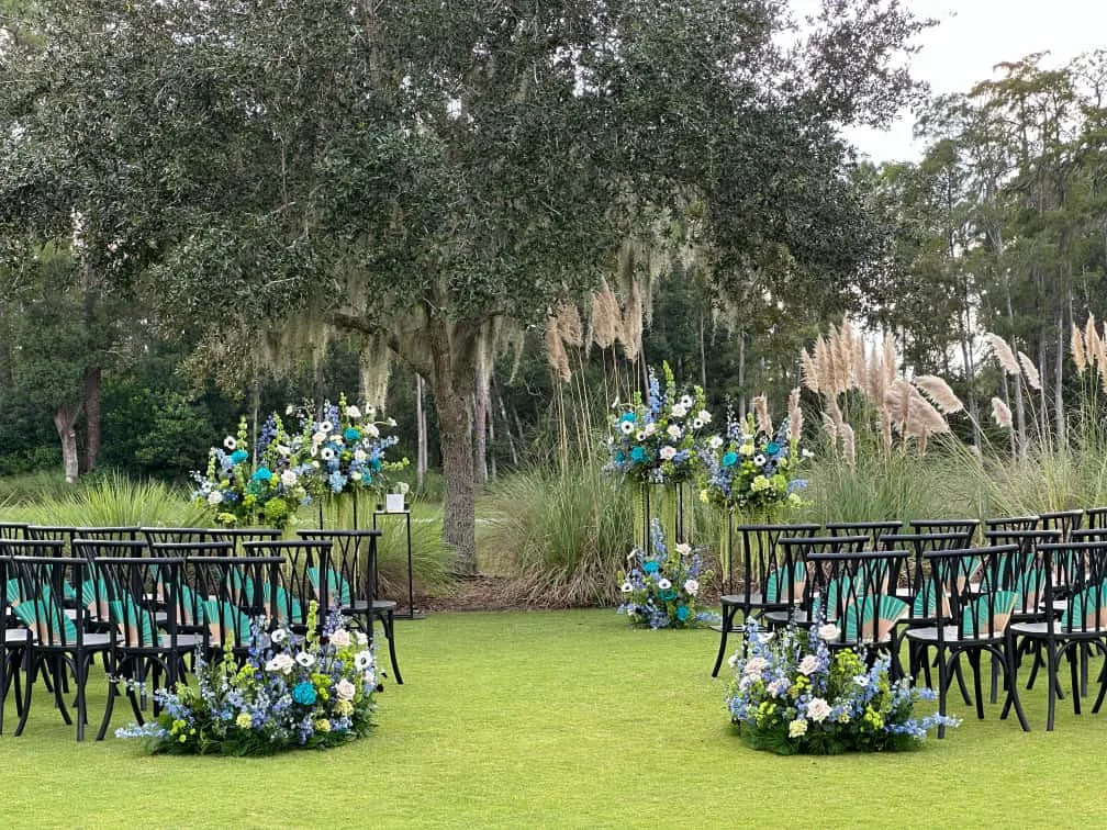 Blue, white, and green outdoor wedding ceremony flowers at Four Seasons Resort Orlando.