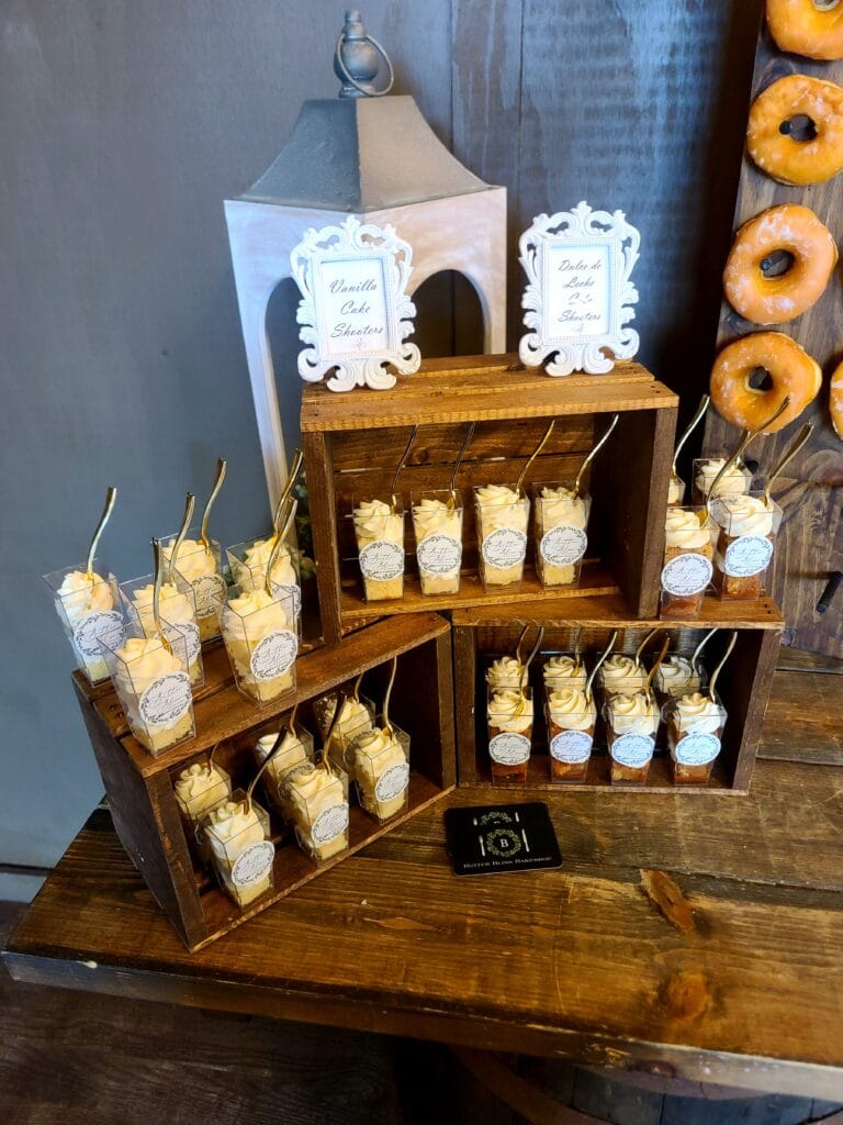 Creamy desserts in parfait cups in wooden mini crates