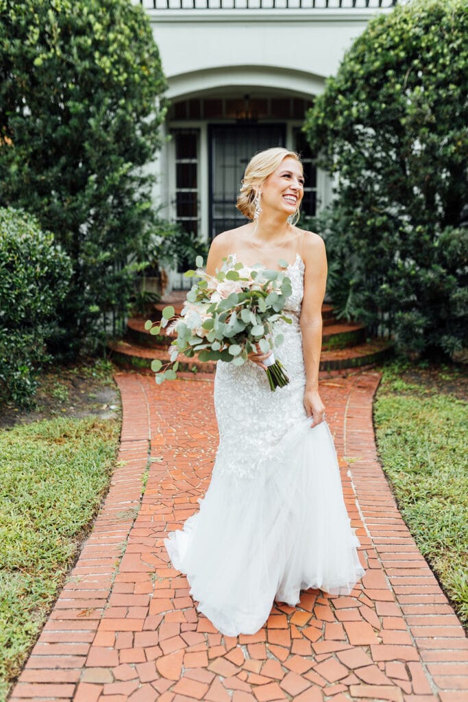 bride walking down brick pathway in front of historic home in deland florida