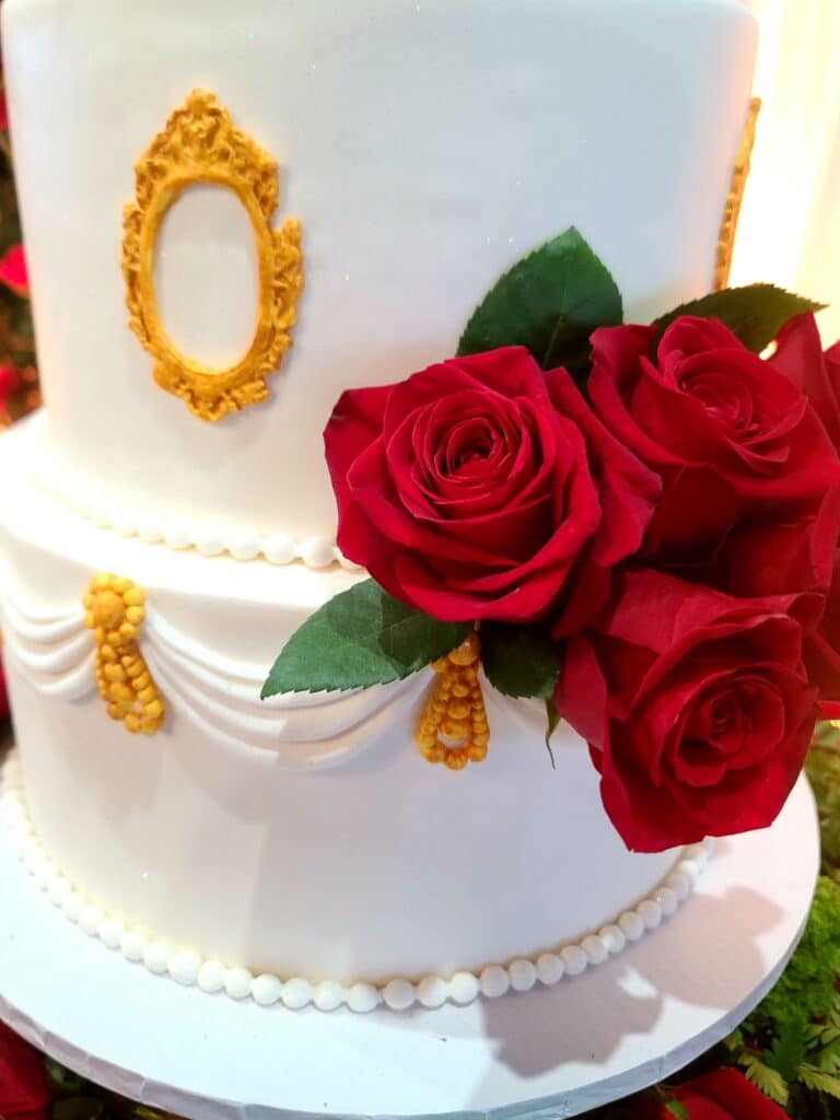 white and gold wedding cake with stunning red roses by Butter Bliss Bakeshop