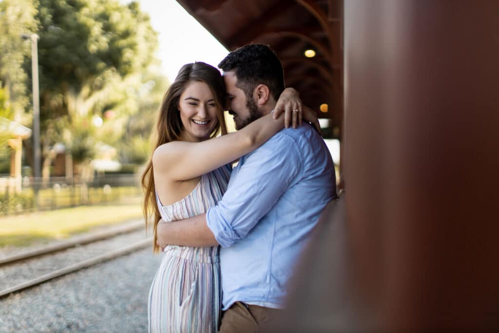 couple hugging by railroad track