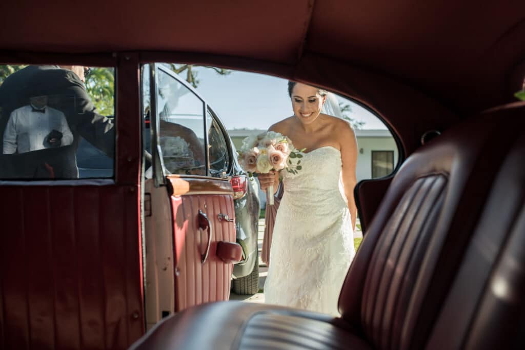 bride entering into limousine