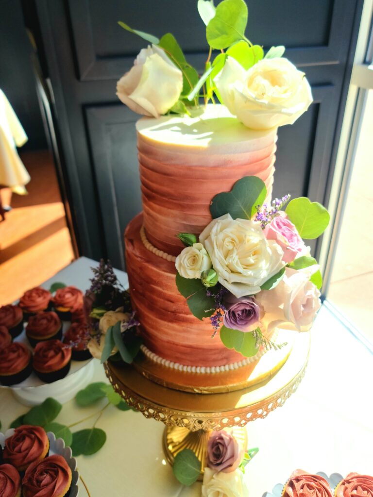 pink wedding cake with white and lavender roses by Butter Bliss Bakeshop