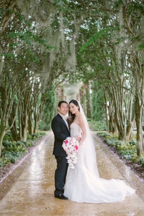 Bride and Groom on walkway with tree canopy