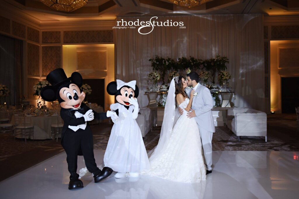 Mickey and Minnie in wedding clothes with Bride and Groom Dancing