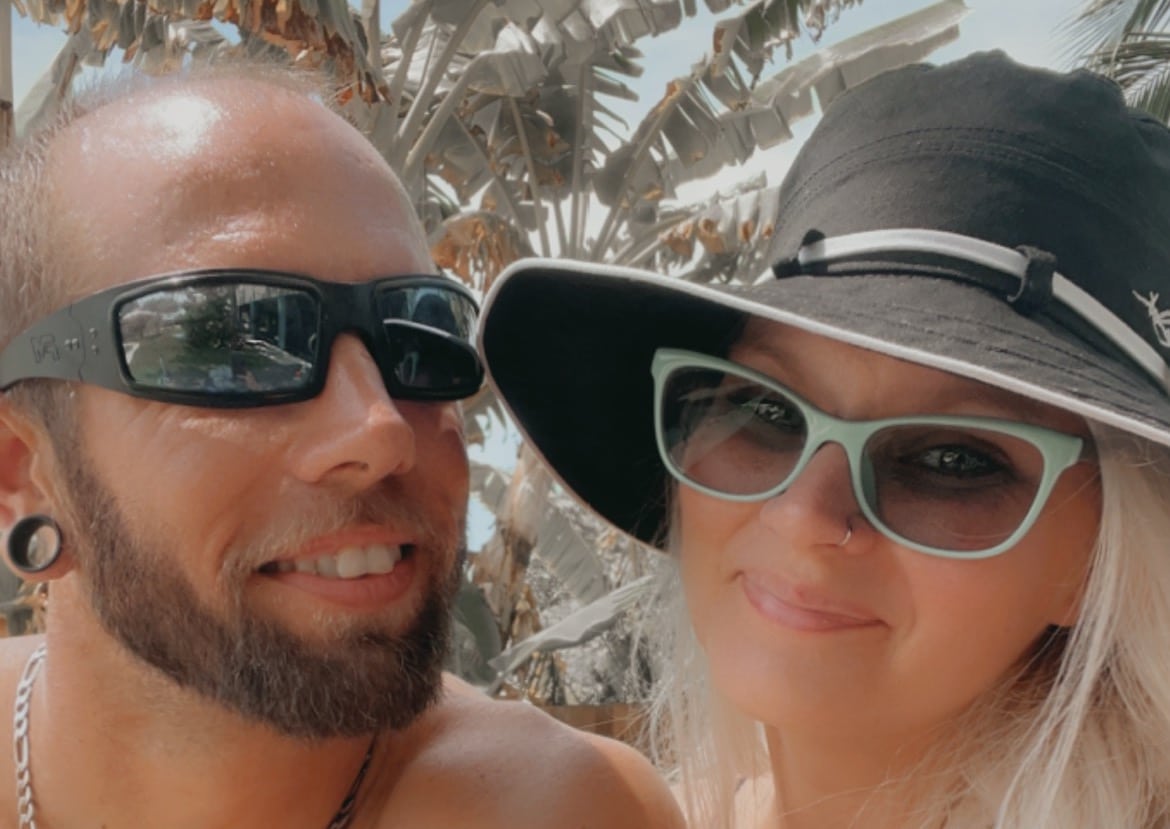 bride and groom to be smiling with sunglasses on after their florida keys marriage proposal.