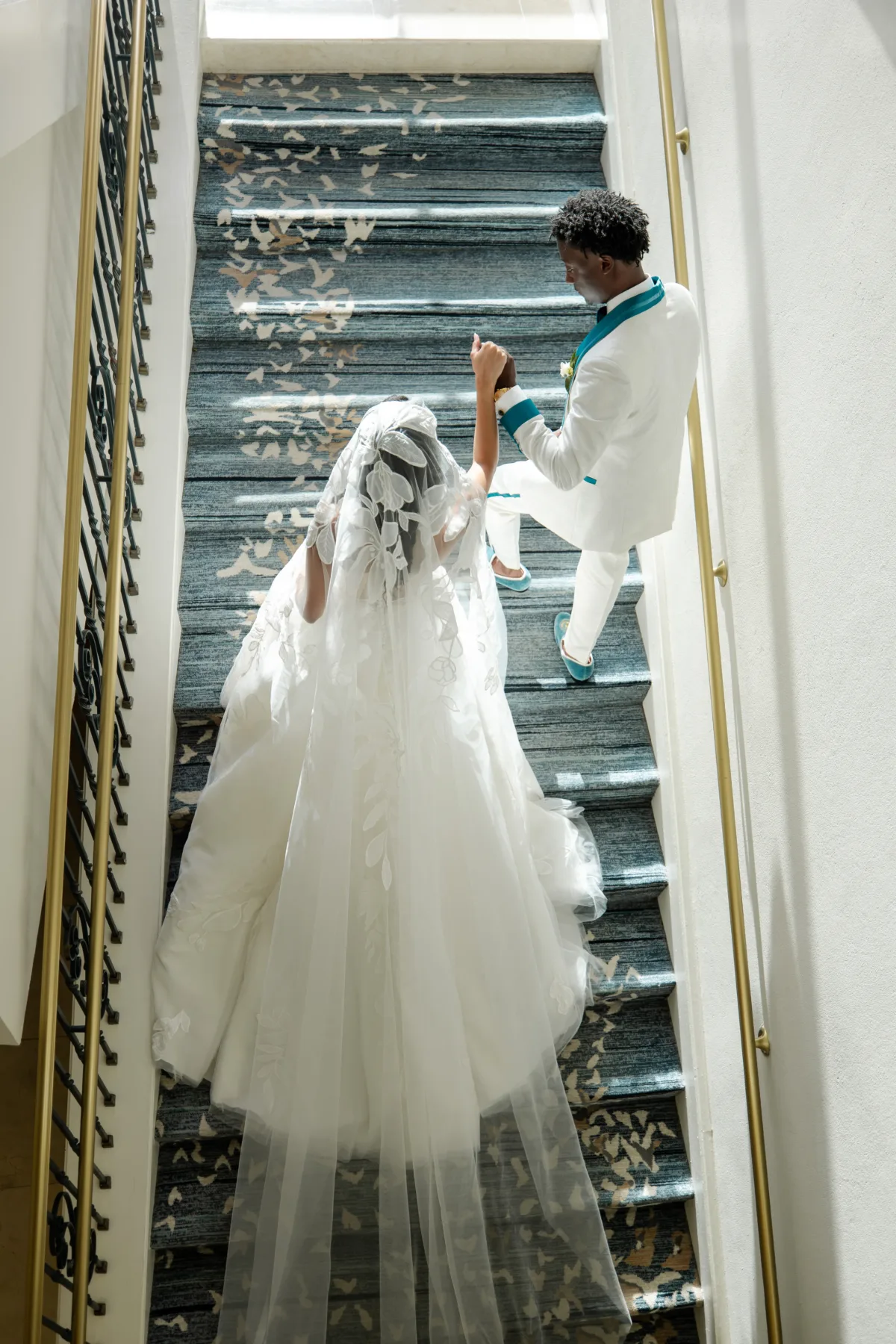Bride and groom stepping up the stairs at the lobby the Omni Orlando Resort