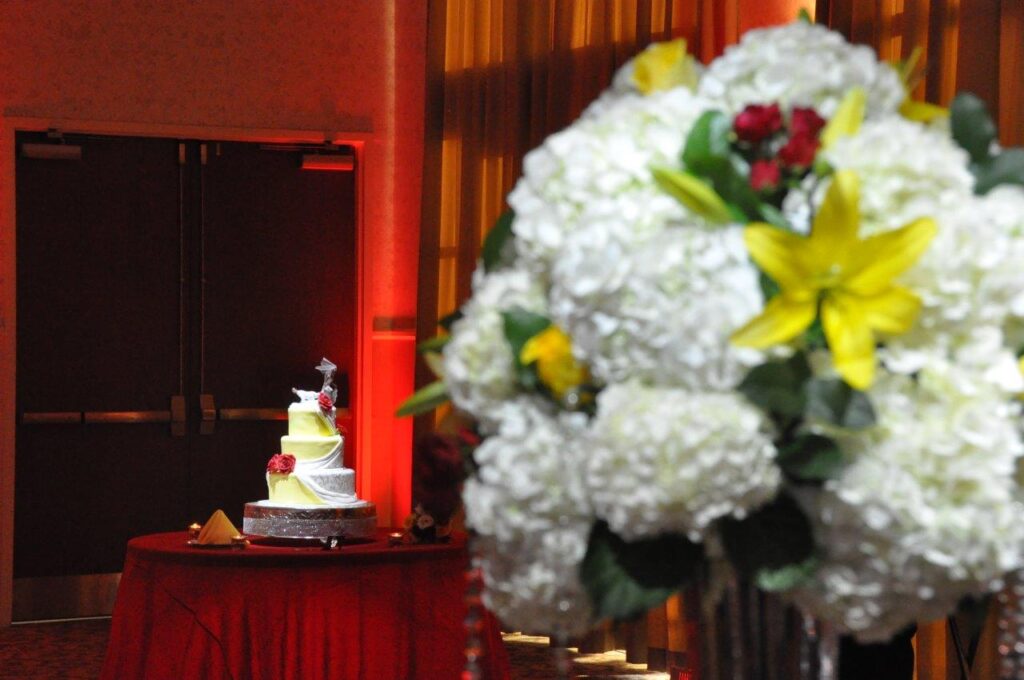 wedding cake with bouquet in foreground