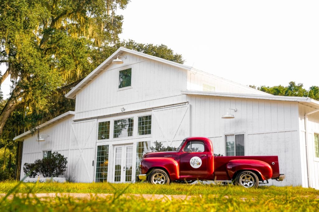 red truck in front of white barn at ever after farms