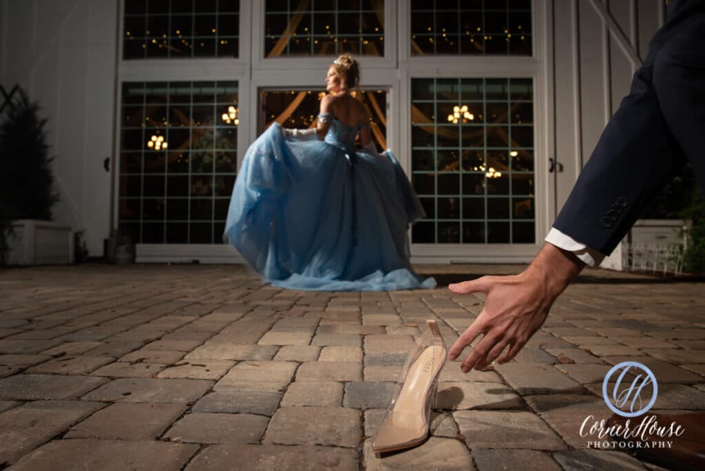 cinderella inspired wedding photo with woman in white dress and shoe left behind