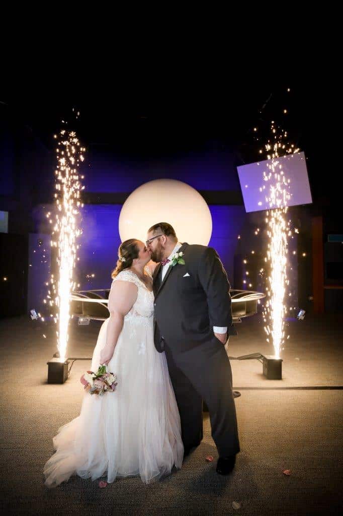 bride and groom kissing with moon background