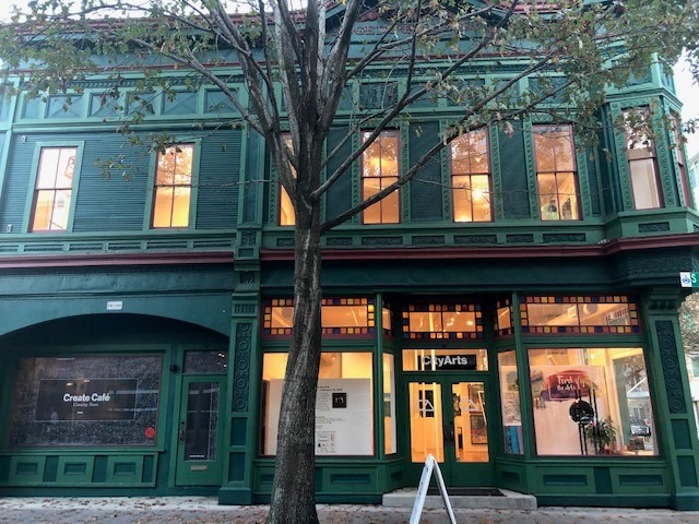dark green victorian building on city street