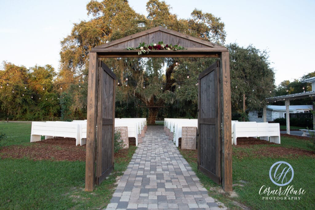 wooden doors and archway leading to outdoor wedding ceremony location