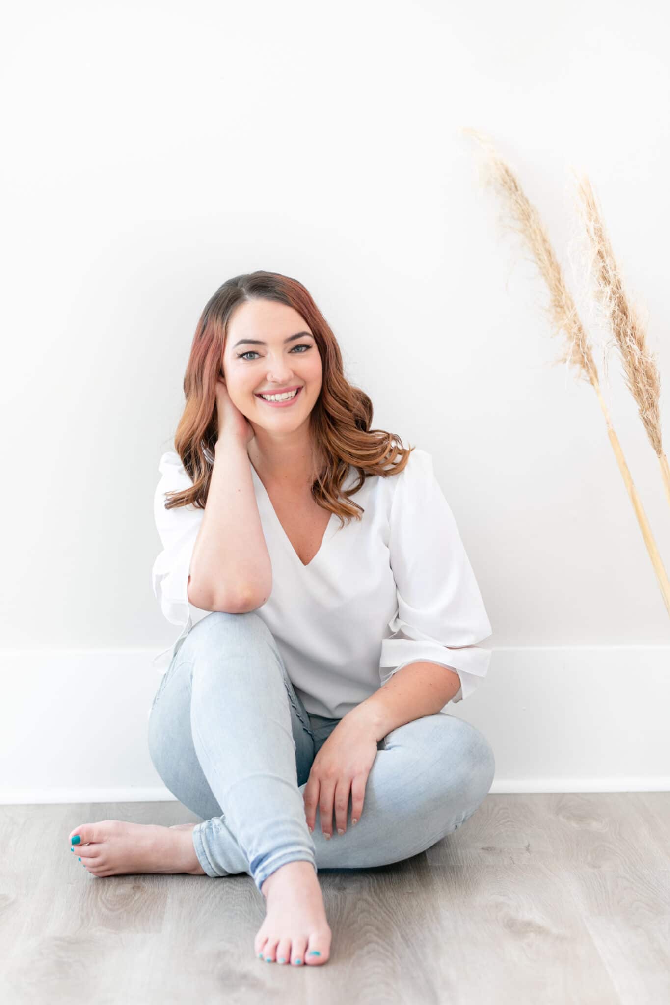 woman smiling against white wall
