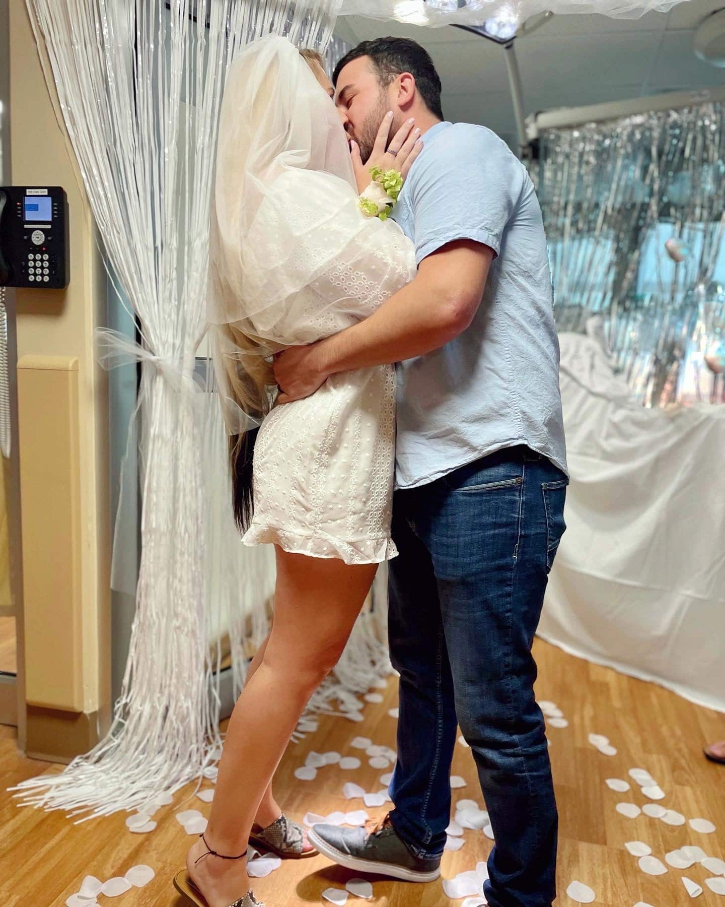 bride and groom kissing in hospital room