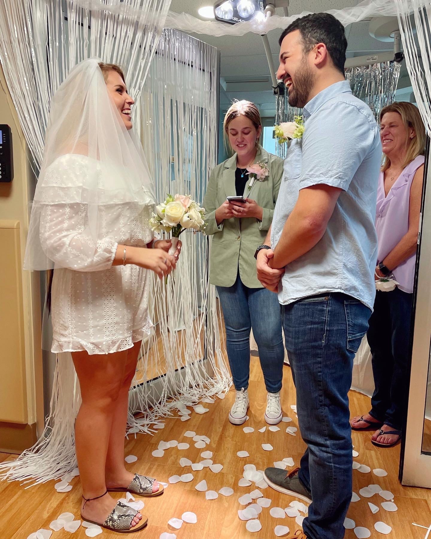 bride and groom during their ceremony at their hospital room wedding.