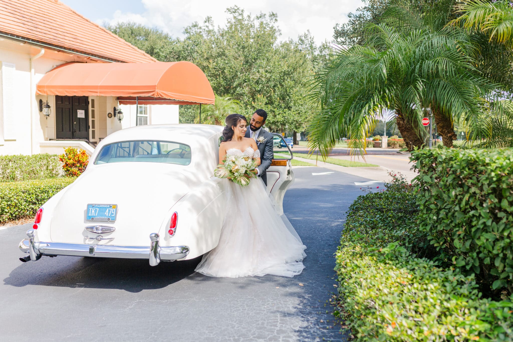 bride and groom arriving at the glamorous gold wedding inspiration styled shoot in a rolls royce.