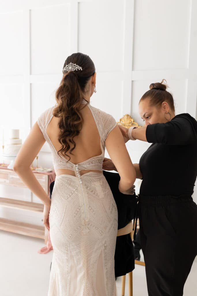 bride being fitted in beautiful gown from Definition Bridal