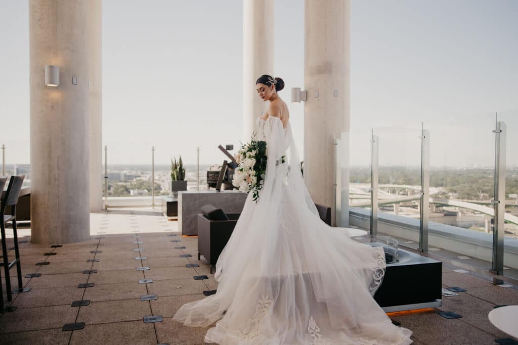 bride in beautiful gown from Definition Bridal on outdoor terrace