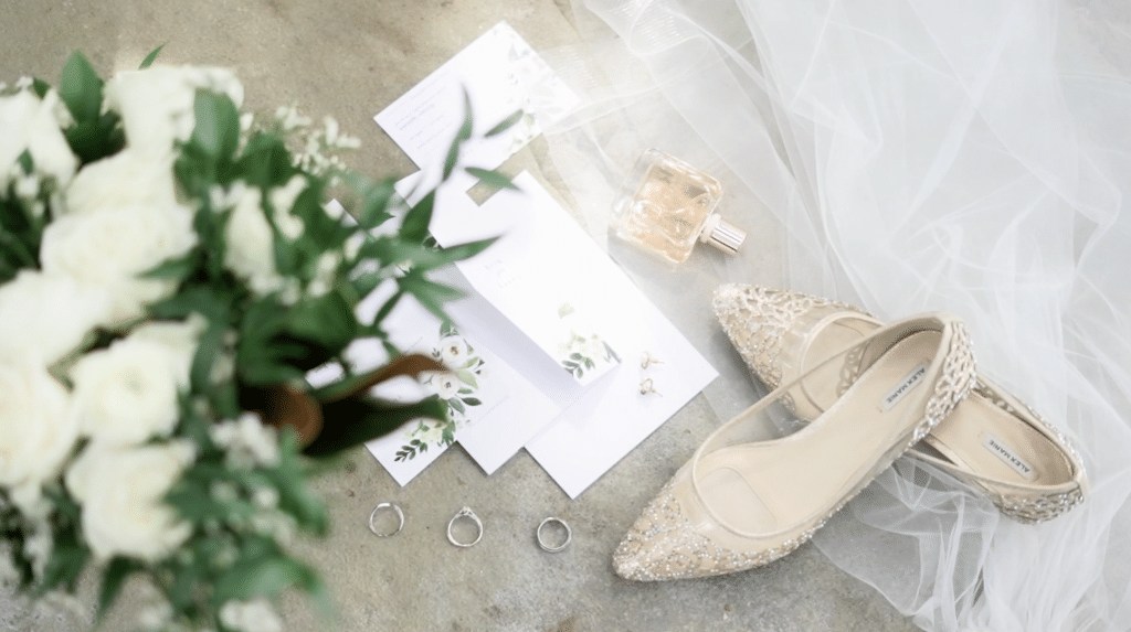 styled photo of wedding bouquet, shoes, rings, and stationary by Lexi Rabelo Films