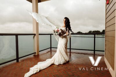 Beautiful bride outside on a verandah overlooking the water