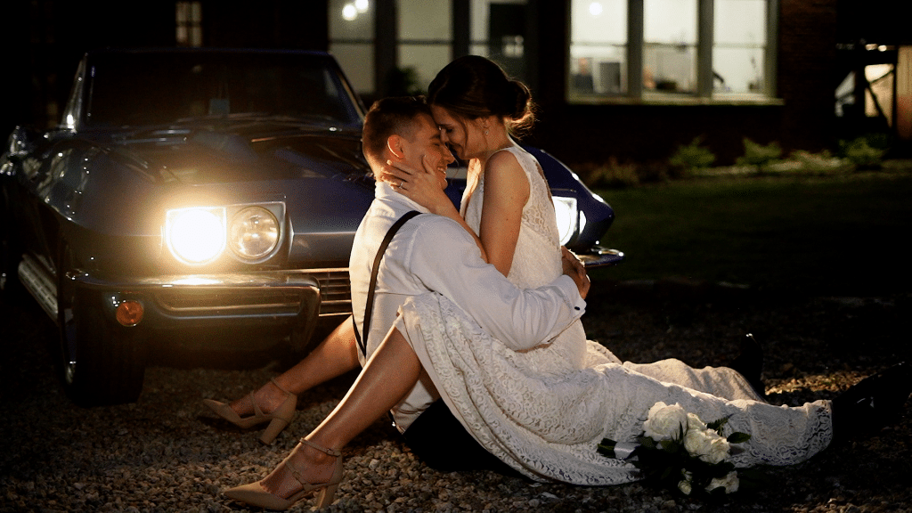 bride straddling groom in light of headlights from car by Lexi Rabelo Films
