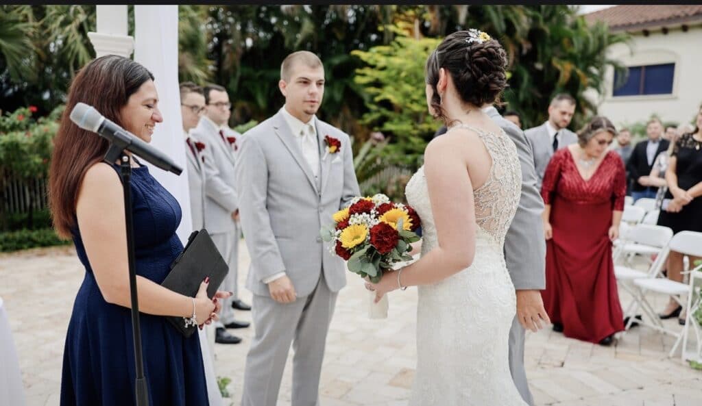 bride and groom in wedding ceremony with officiant Chrissie from Ceremonies by Chrissie looking on