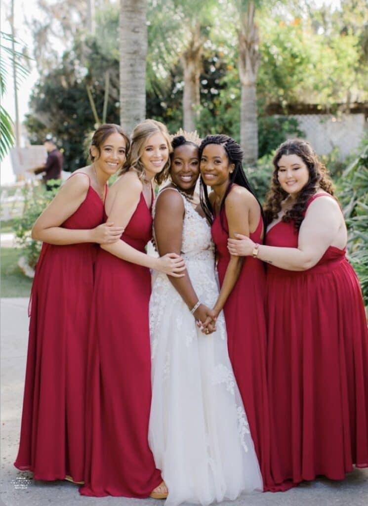 bride with bridesmaids in red