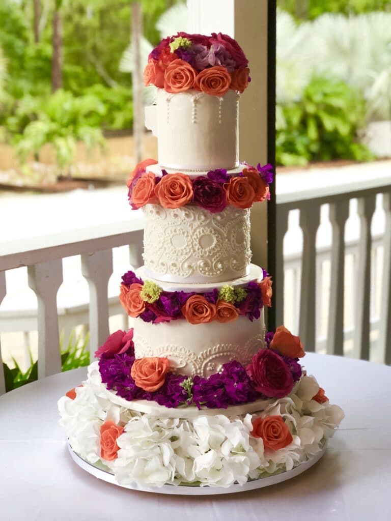 wedding cake with red ombre flowers around tiers by I heart cakes by Yari