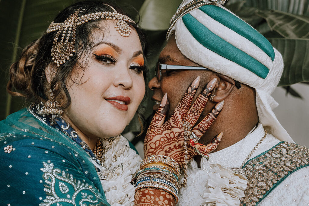 Bride and groom close up. They are wearing traditional wedding attire
