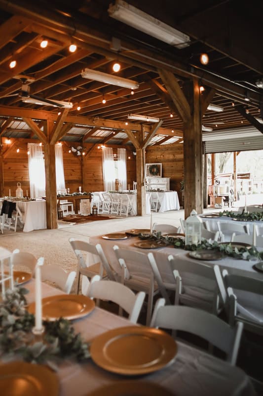 barn, wooden rafters, white chairs, gold chargers, white candles, Still Creek Farm, Central, FL