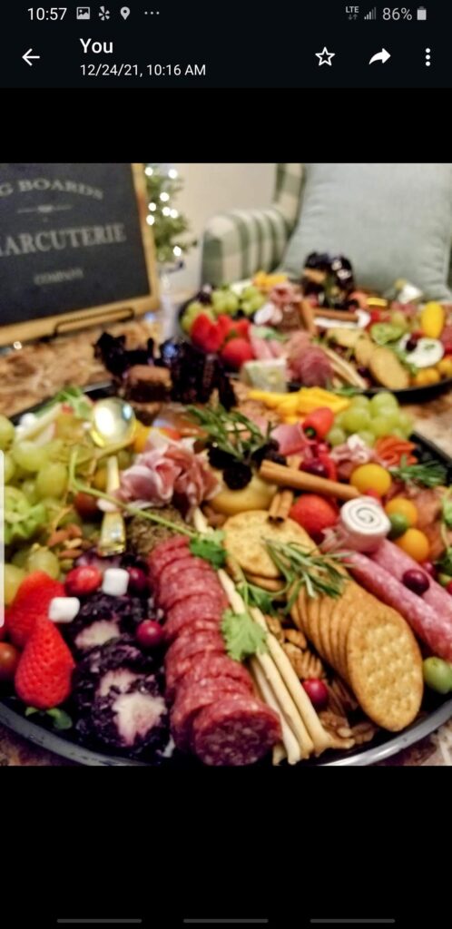 board with meats, cheeses, and fruits