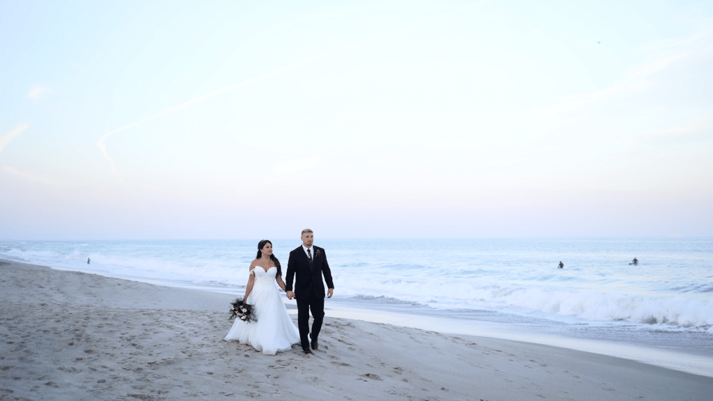 Lexi Rabelo Films bride and groom walking down the beach