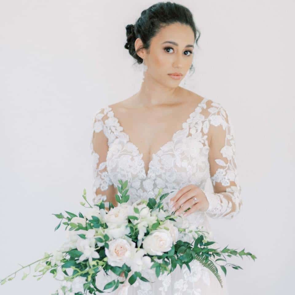 bride with lace dress and green bouquet