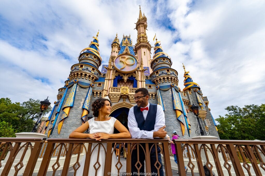 Bride and groom looking at each other in front of the Magic Kingdom castle