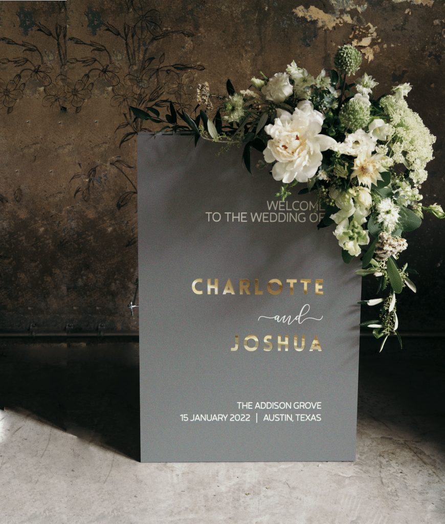 table sign of grey with gold letters and white flowers by Petal & Grain