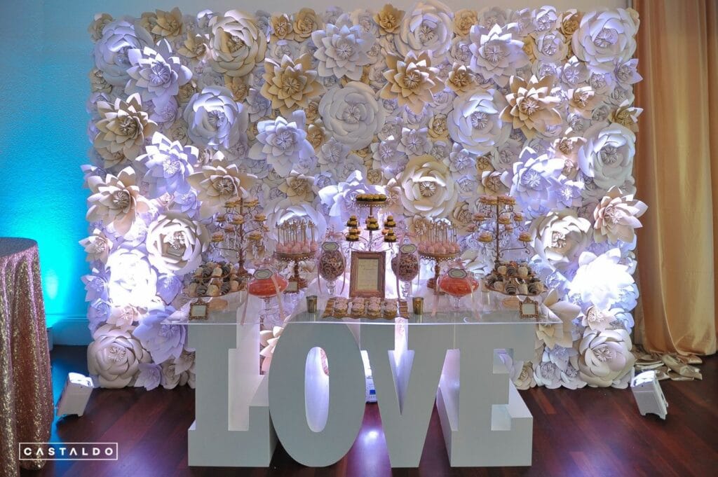 LOVE table with large flower wall behind it by Petal & Grain