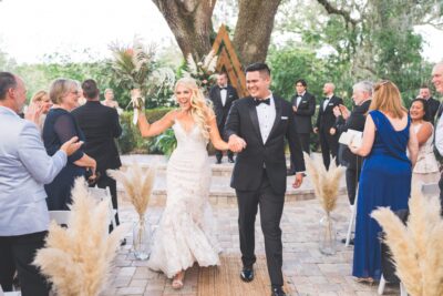 Bride and groom walking down the aisle after getting married
