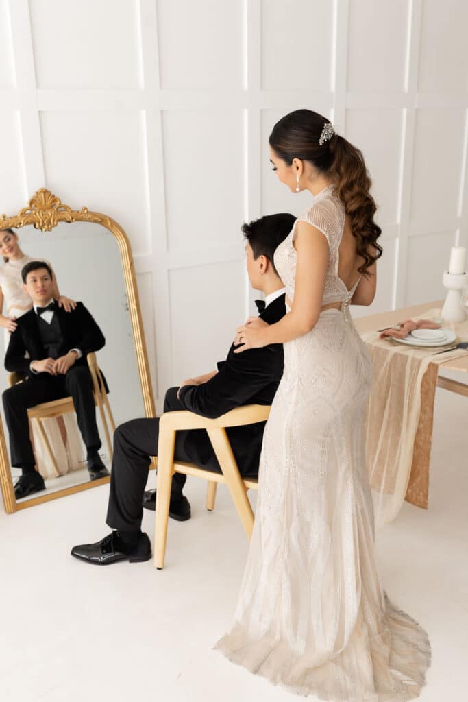 bride in beautiful gown from Definition Bridal reflected in mirror with groom