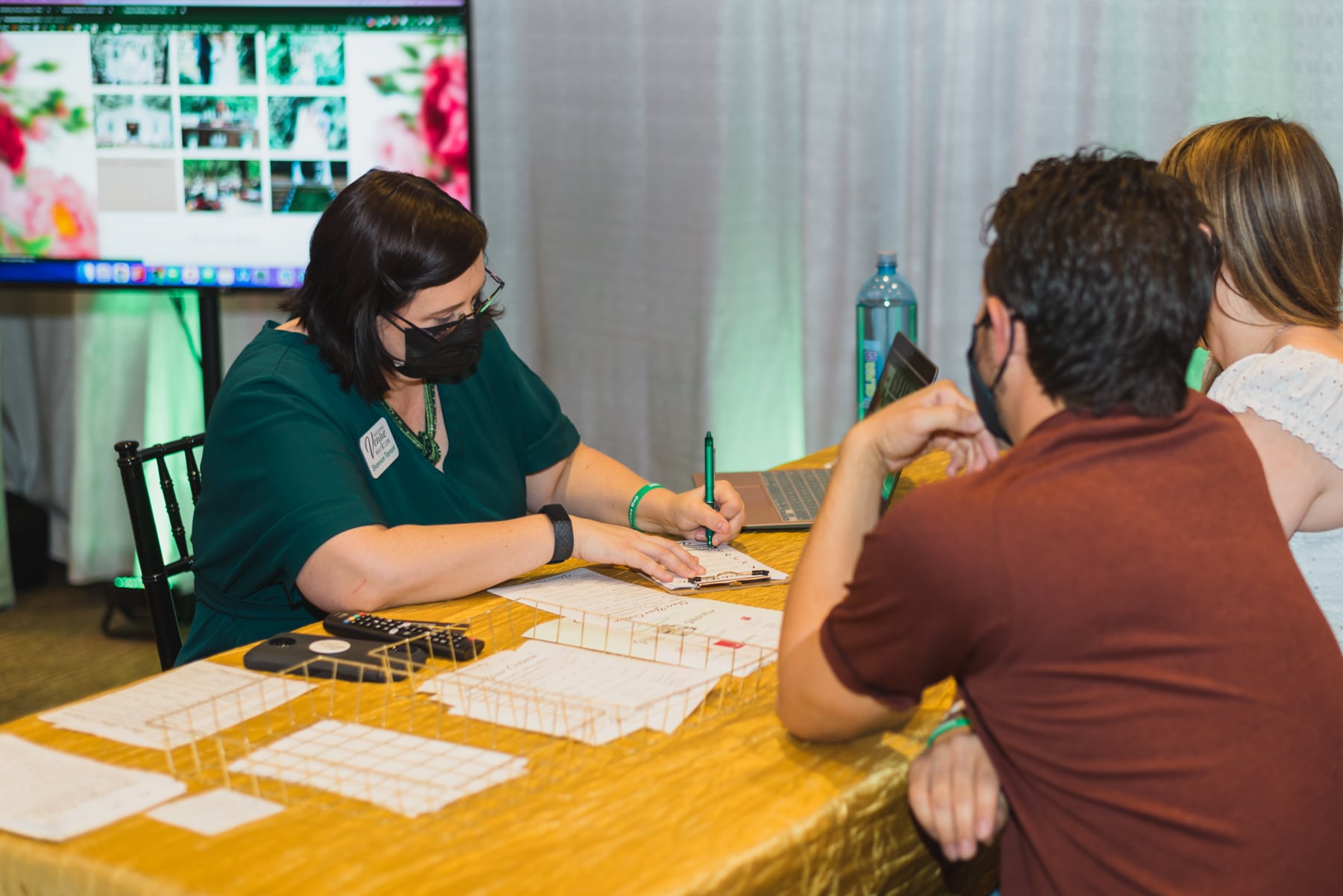woman helping couple find a venue at The Venue Experience at the Florida Wedding Expo