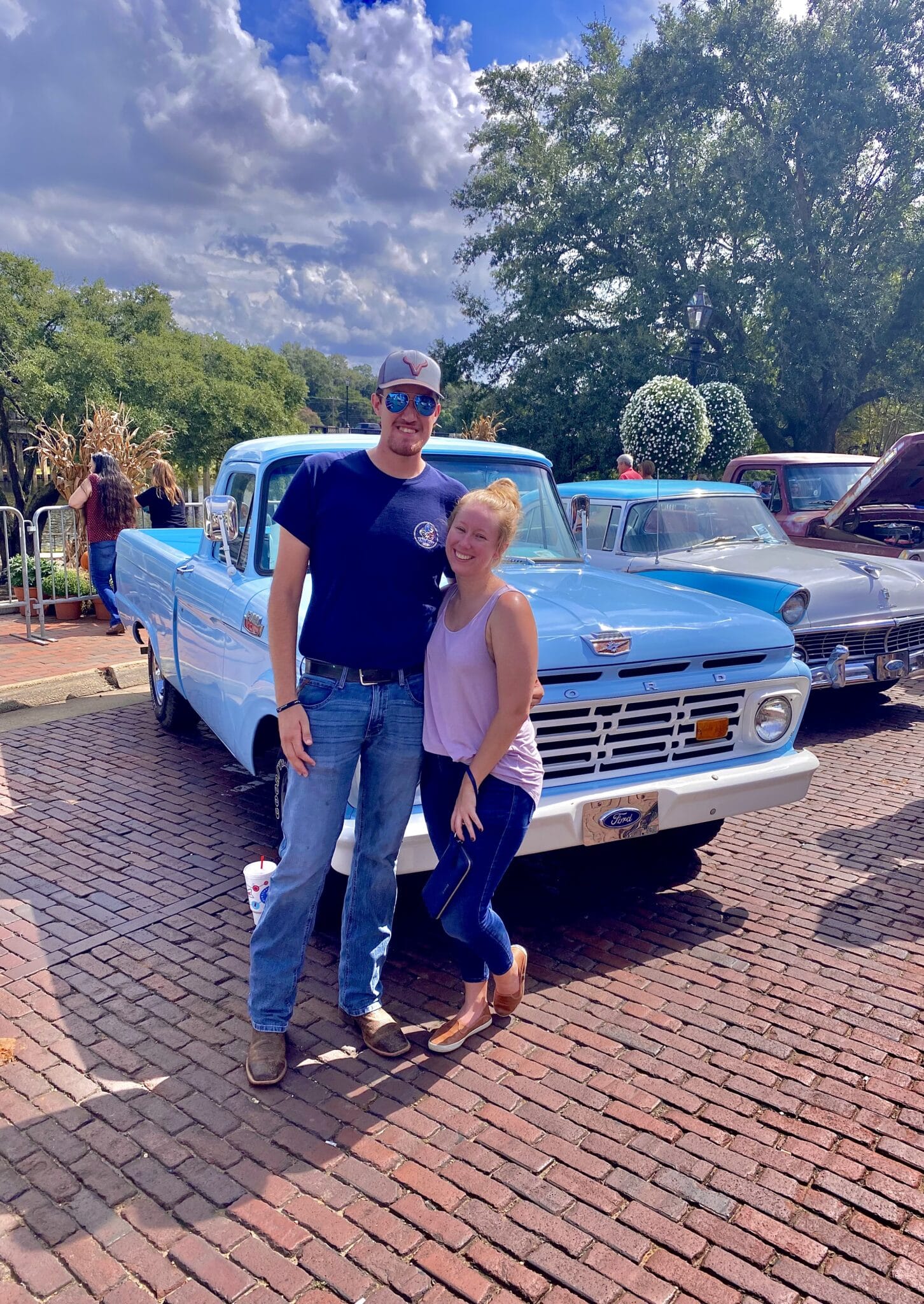 couple in front of blue Chevy classic truck
