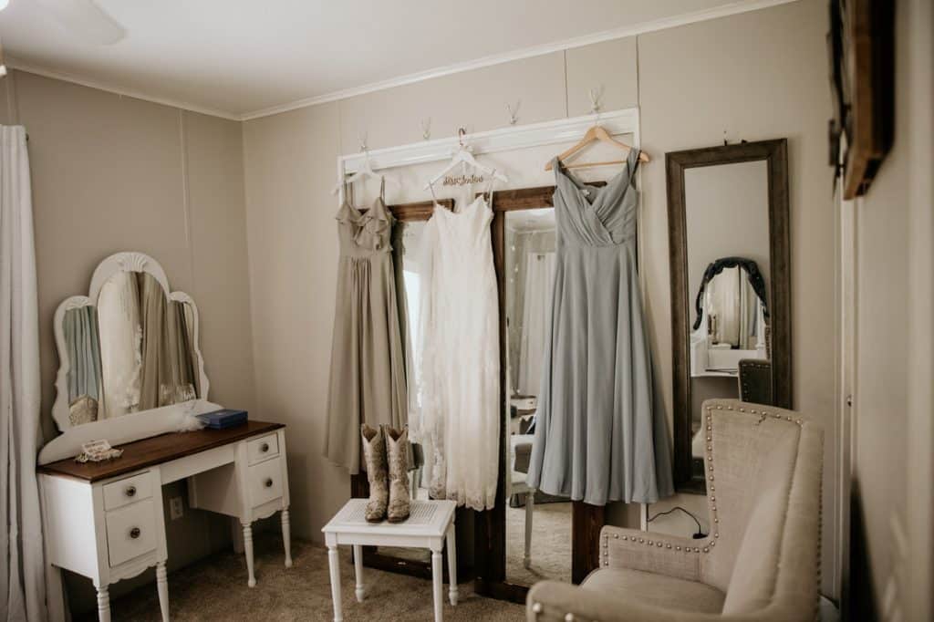 wedding dress and bridesmaid dresses hanging in the bridal suite, Still Creek Farm, Central, FL