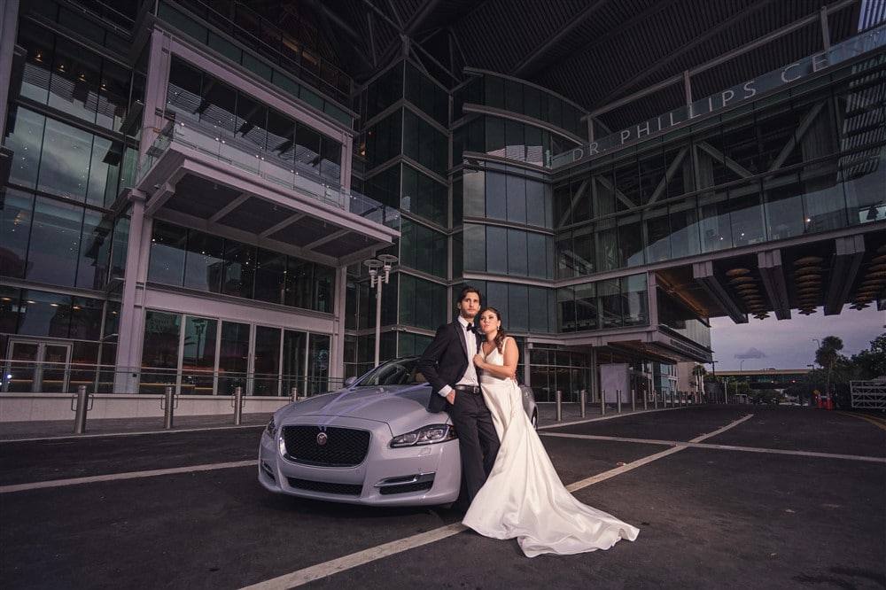 bride and groom in modern parking lot at night for moody photograph