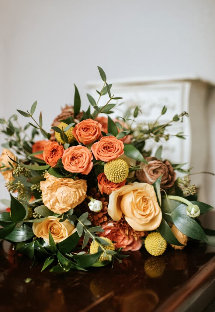 stunning bouquet of ombre roses in oranges, salmon and autumnal colors by Joanna Moore Photography