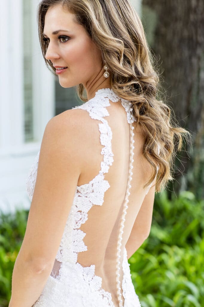 bride with lace and button backed wedding gown photographed by Sterling Photography International