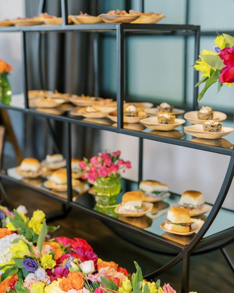 burger bar with colorful flowers by Puff 'n Stuff Catering